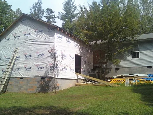 Tyvek wrapped gable on a new room addition beside an existing home in Littleton